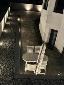 a table and chairs on a patio at night at Ferienwohnung Rastenberg in Rastenberg