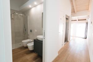 a bathroom with a toilet sink and a shower at City Boutique in Porto Torres +34 photos