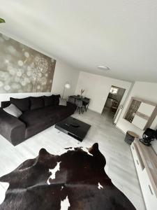 a living room with a couch and a dog laying on the floor at Ferienwohnung Rastenberg in Rastenberg
