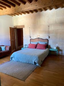 a bedroom with a large bed with red pillows at Le Patio d'Arles in Arles