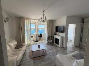 a living room with a couch and a table at Apartman Cezar2 in Rogoznica
