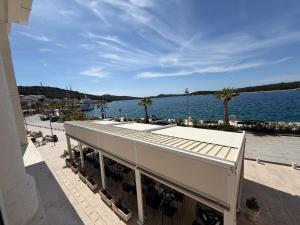 a building with a view of a body of water at Apartman Cezar2 in Rogoznica