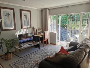 a living room with a couch and a table at The Boho Suite in Benoni