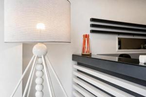 a white lamp sitting on top of a table at Hotiday Napoli Porto in Naples