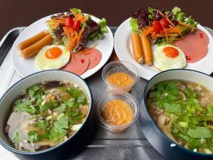 a table with plates of food and bowls of soup at Mireya Resort Khaoyai in Ban Khanong Phra Nua