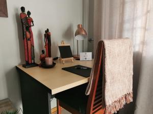 a desk with a lamp on top of it at The Boho Suite in Benoni +16 photos