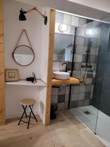 a bathroom with a sink and a shower at Le petit chalet in Mazaye