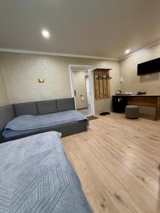 a large room with a bed and a table at Sky 28 in Almaty