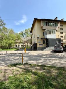 a car parked in a parking lot in front of a building at Sky 28 in Almaty