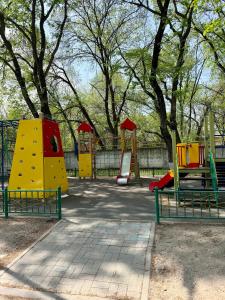 a playground with colorful play equipment in a park at Sky 28 in Almaty