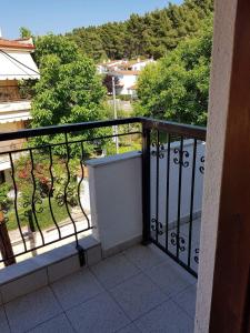 a balcony with a view of a yard with trees at Airy and cosy summer flat in Siviri