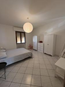 a bedroom with a bed and a table and a lamp at Civico 107 in Capolona