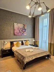 a bedroom with a large bed and a large window at Hirscher Loft in Braşov +28 photos