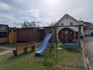 a playground with a slide in a yard at Schlaffass auf der Fischer-Ranch in Westerheim