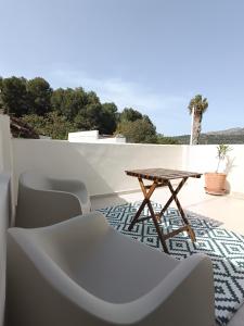 a table and chairs on a patio with a view at La Llar de la Font in Barraca de Aguas Vivas
