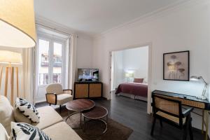 a living room with a room with a bed and a desk at Suite Prado in Madrid