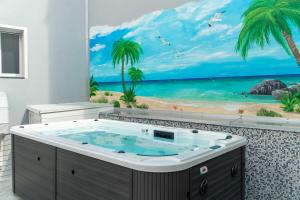 a jacuzzi tub in a bathroom with a beach mural at Cattleya Rooms in Sestu +10 photos