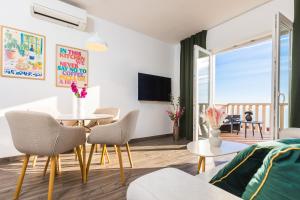 a living room with a table and chairs at Marojica Apartments 2 in Cavtat