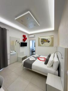 a bedroom with a bed with a red balloon on it at Cattleya Rooms in Sestu