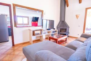 a living room with a couch and a stove at Casa Ailen in Islas Baleares