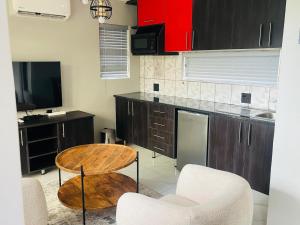 a kitchen with a table and two chairs and a counter at Xitshavani Lodge in Phalaborwa