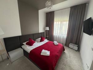 a bedroom with a large bed with red pillows at Копа Баварія - Львів Готель in Pasiky-Zubryts'ki
