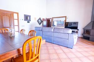 a living room with a table and a couch at Casa Ailen in Islas Baleares