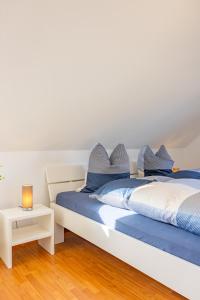 a bedroom with two beds and a night stand at Haus Altburgstädtel in Dresden