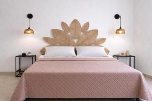 a bedroom with a large bed with two side tables at Masseria Coccolo in Carovigno