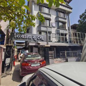 a red car parked in front of a building at Sienna Suites in Navi Mumbai