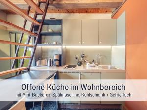 an open kitchen with a ladder in a house at Isetta Wettelsteck - Mini Ferienhaus in Kyritz, einer charmanten Stadt im Herzen von Brandenburg in Kyritz
