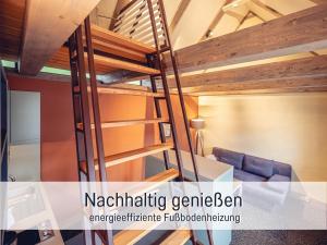 a loft bed in a room with a ladder at Isetta Wettelsteck - Mini Ferienhaus in Kyritz, einer charmanten Stadt im Herzen von Brandenburg in Kyritz
