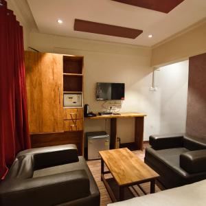 a living room with a couch and a table at Sienna Suites in Navi Mumbai