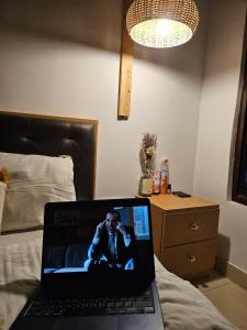 a laptop computer sitting on top of a bed at Sukoon in Nainital