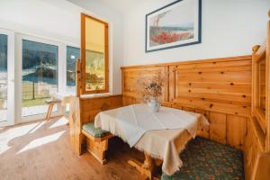 a room with a table with a vase on it at Landhaus Gerstgraser in Rauris