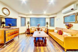 a living room with a couch and a table at Neocolonial Quarters in Vancouver