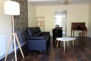 a living room with a couch and a table at Graine in Dommartin-le-Franc