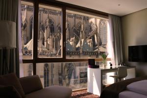 a room with a view of a building through a window at Hotel Am Domplatz - Adult Only in Linz