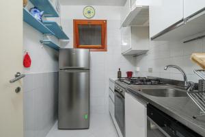 a kitchen with a sink and a stove at Marana Orizzonte in Santa Marinella