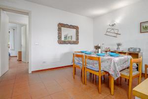 a dining room with a table and chairs and a mirror at Marana Orizzonte in Santa Marinella