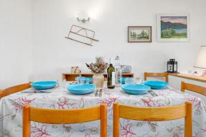a dining room table with blue bowls on it at Marana Orizzonte in Santa Marinella