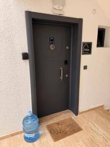 a bottle of water sitting in front of a door at AQUA Suite Kemer in Kemer +11 photos