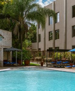 a swimming pool in front of a building at Radisson Blu Hotel Lusaka in Lusaka