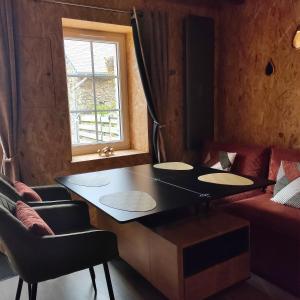 a room with a table and chairs and a window at B&B suite de charme in Guipry-Messac