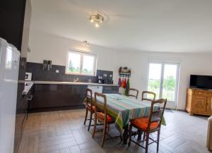 a kitchen and dining room with a table and chairs at Le repere in Tocane-Saint-Apre
