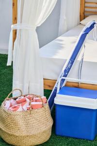 a basket next to a bed with a mattress at CASA CALMA Blanes in Blanes