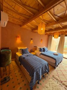 a bedroom with two beds in a room at La Perle de Neige in Imlil