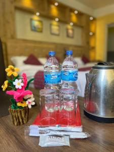 two bottles of water sitting on top of a table at Hotel Sambridhi in Panepa