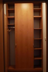 a closet with a wooden door and shelves at Horská bouda Aldrov in Vítkovice