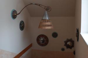 a bathroom with a chandelier hanging from a wall at Horská bouda Aldrov in Vítkovice